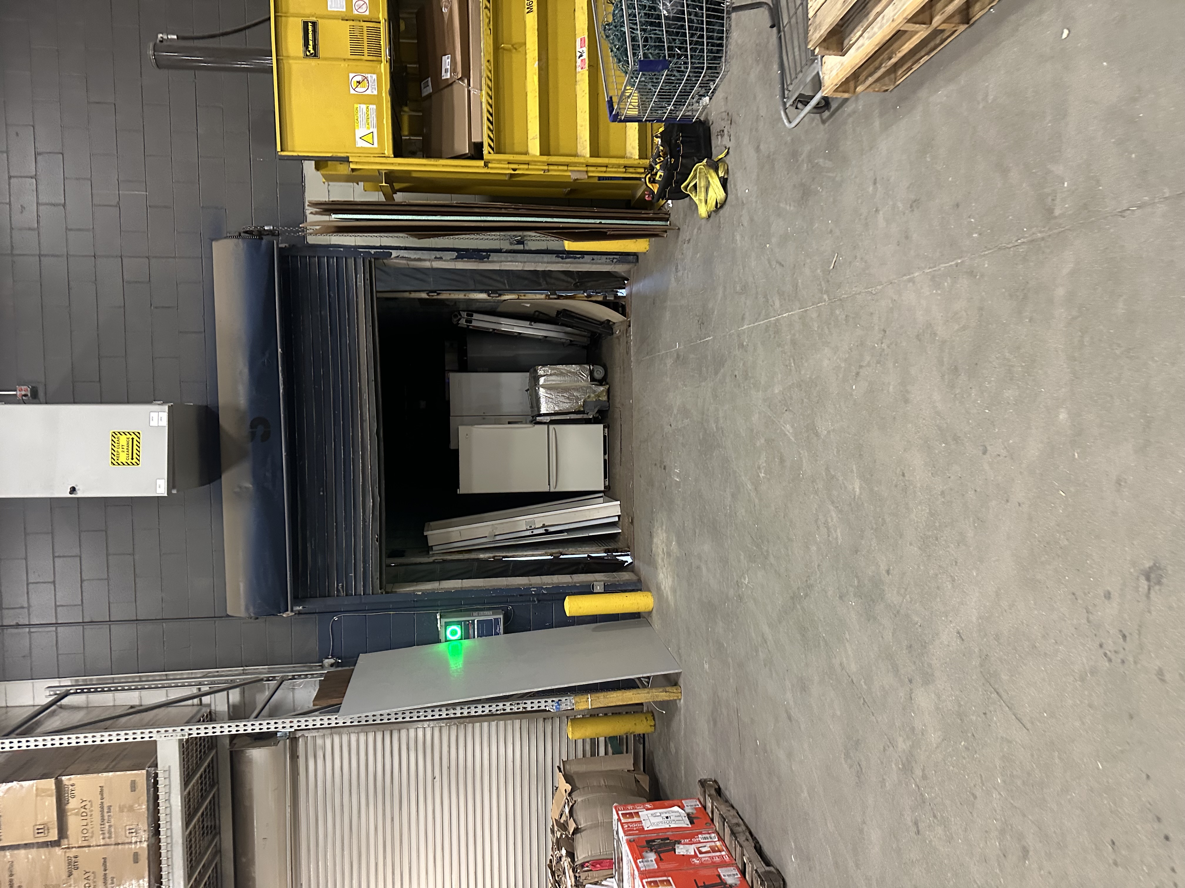 Commercial garage door panels and equipment at a warehouse facility ready for installation